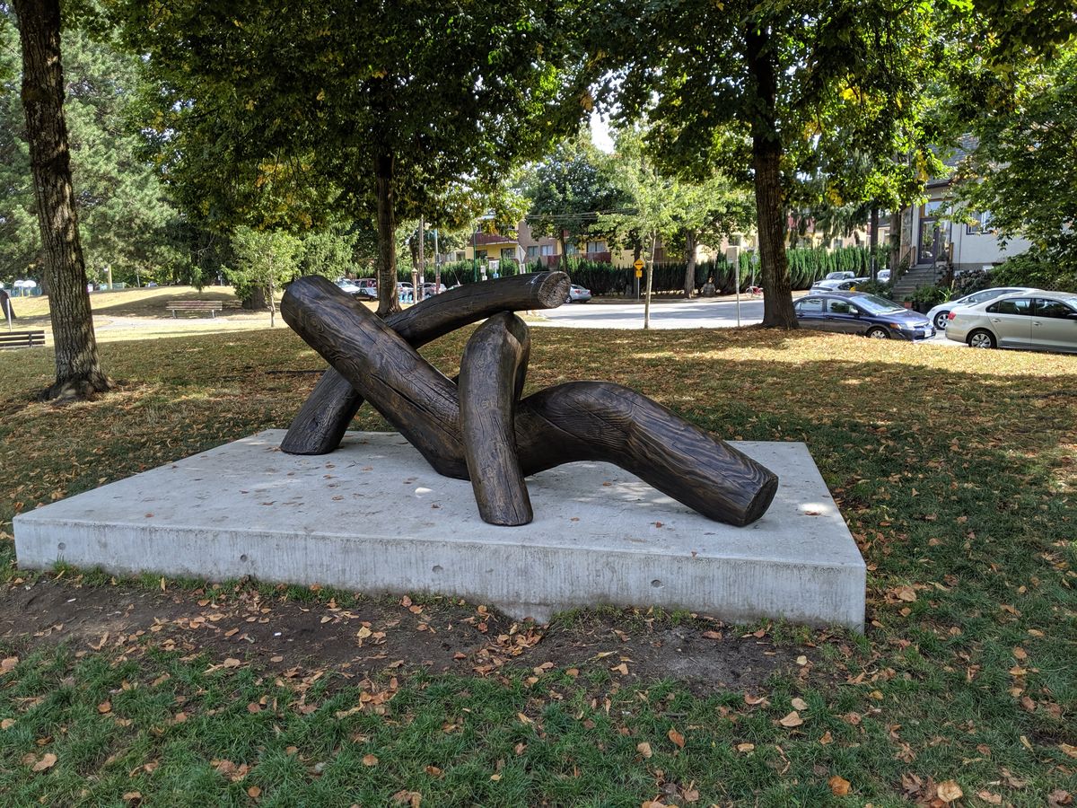 Reclining figure sculpture on a concrete platform in Dude Chilling Park